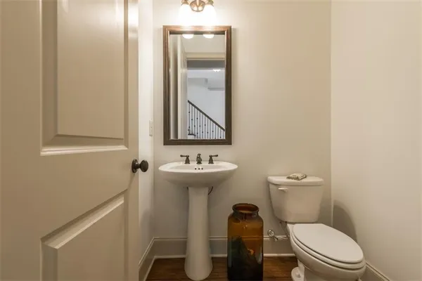 a white toilet sitting next to a bathroom sink