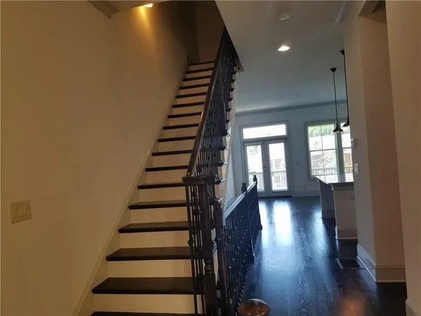 a view of entryway and hall with wooden floor
