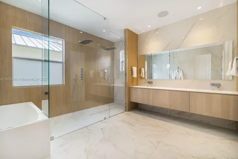 a bathroom with a double vanity sink mirror and shower