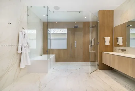 a bathroom with a tub sink and mirror
