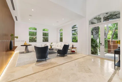 a living room with furniture and large windows