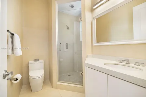 a bathroom with a sink shower and a mirror