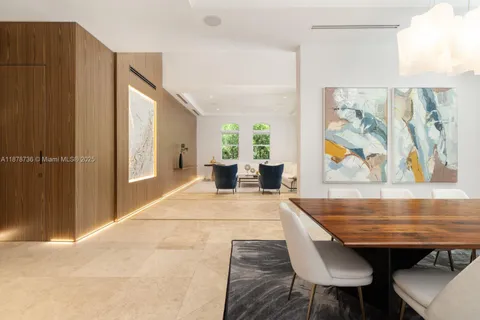a view of a dining room with furniture a chandelier and wooden floor