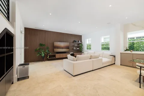 a living room with furniture flat screen tv and a fireplace