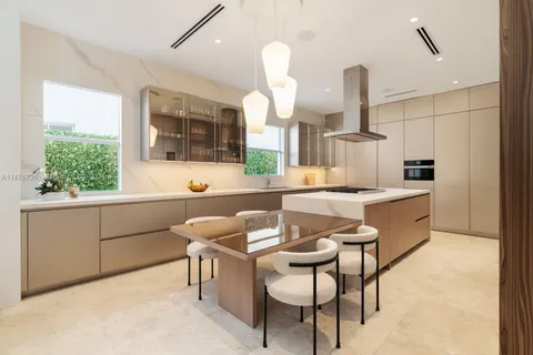 a kitchen with a table chairs sink and cabinets