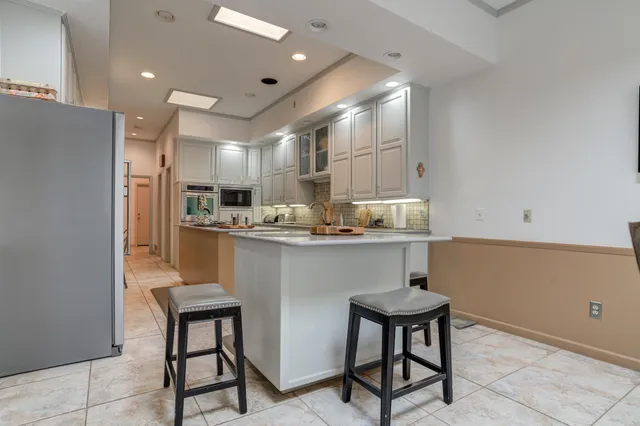 a kitchen with stainless steel appliances granite countertop a refrigerator sink and cabinets