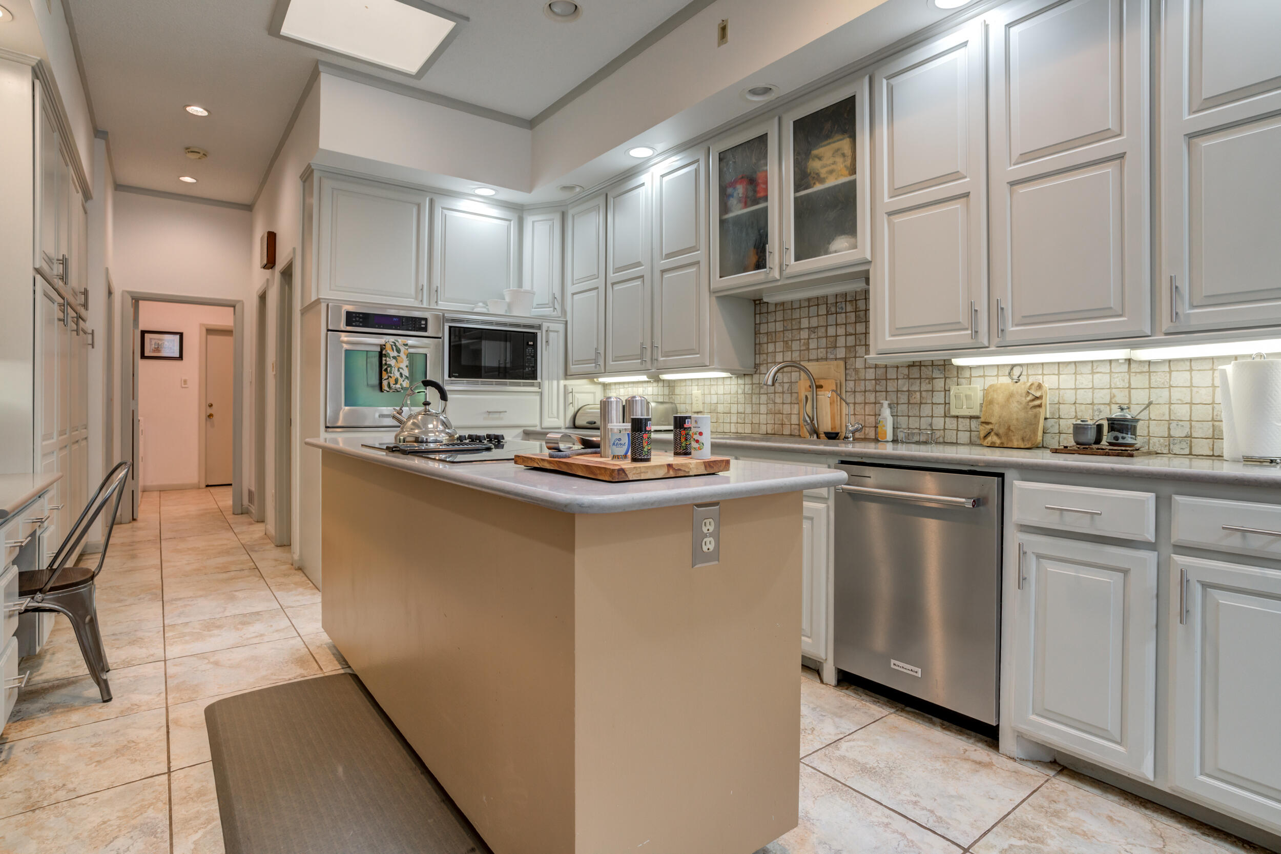 4528 7th Street Lubbock, TX 79416 - Photo 15 of 69 a kitchen with stainless steel appliances granite countertop a refrigerator sink and cabinets