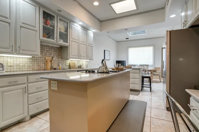 a living room with furniture a fireplace and a large window