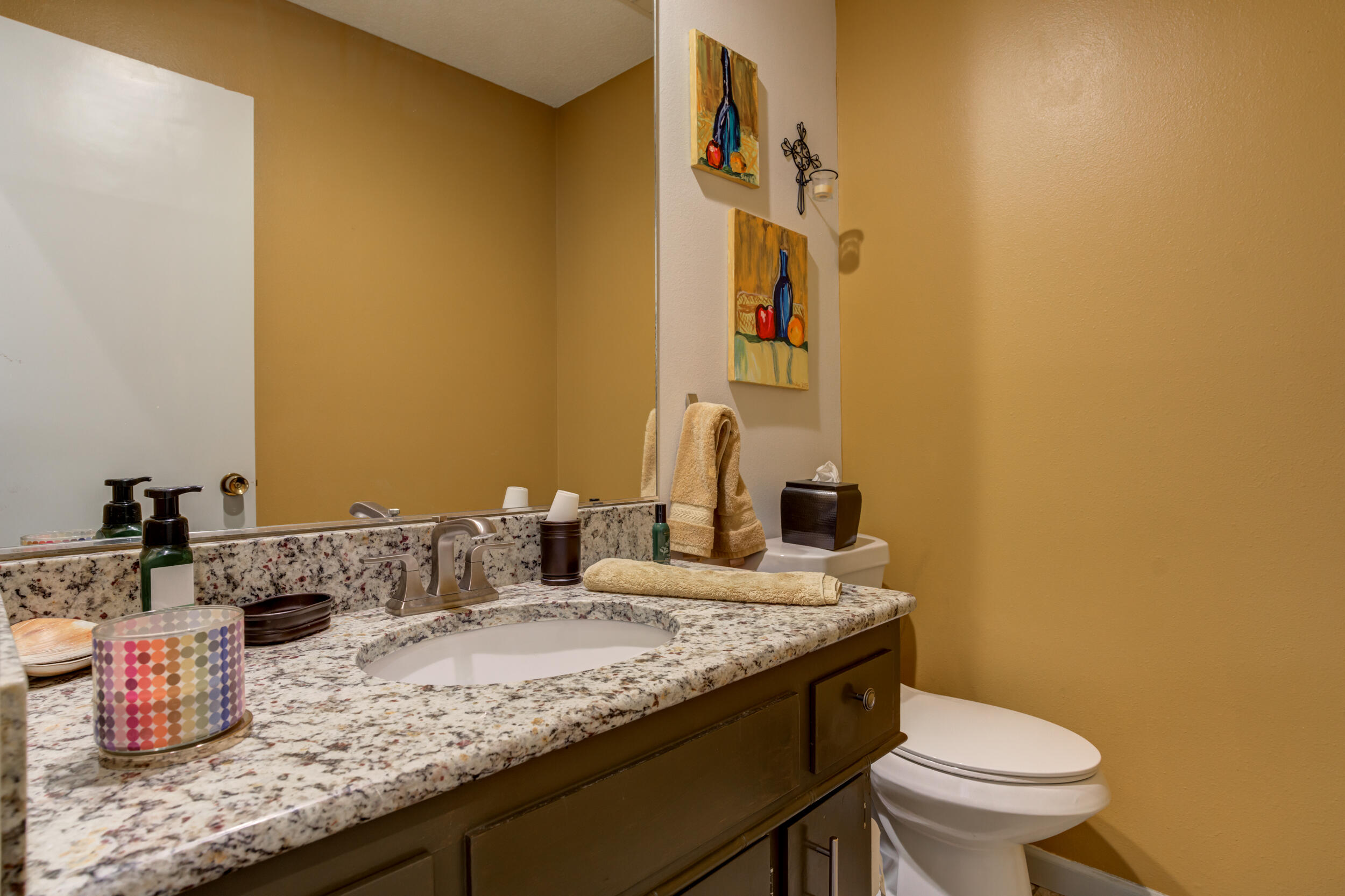 4528 7th Street Lubbock, TX 79416 - Photo 20 of 69 a bathroom with a granite countertop sink and a toilet