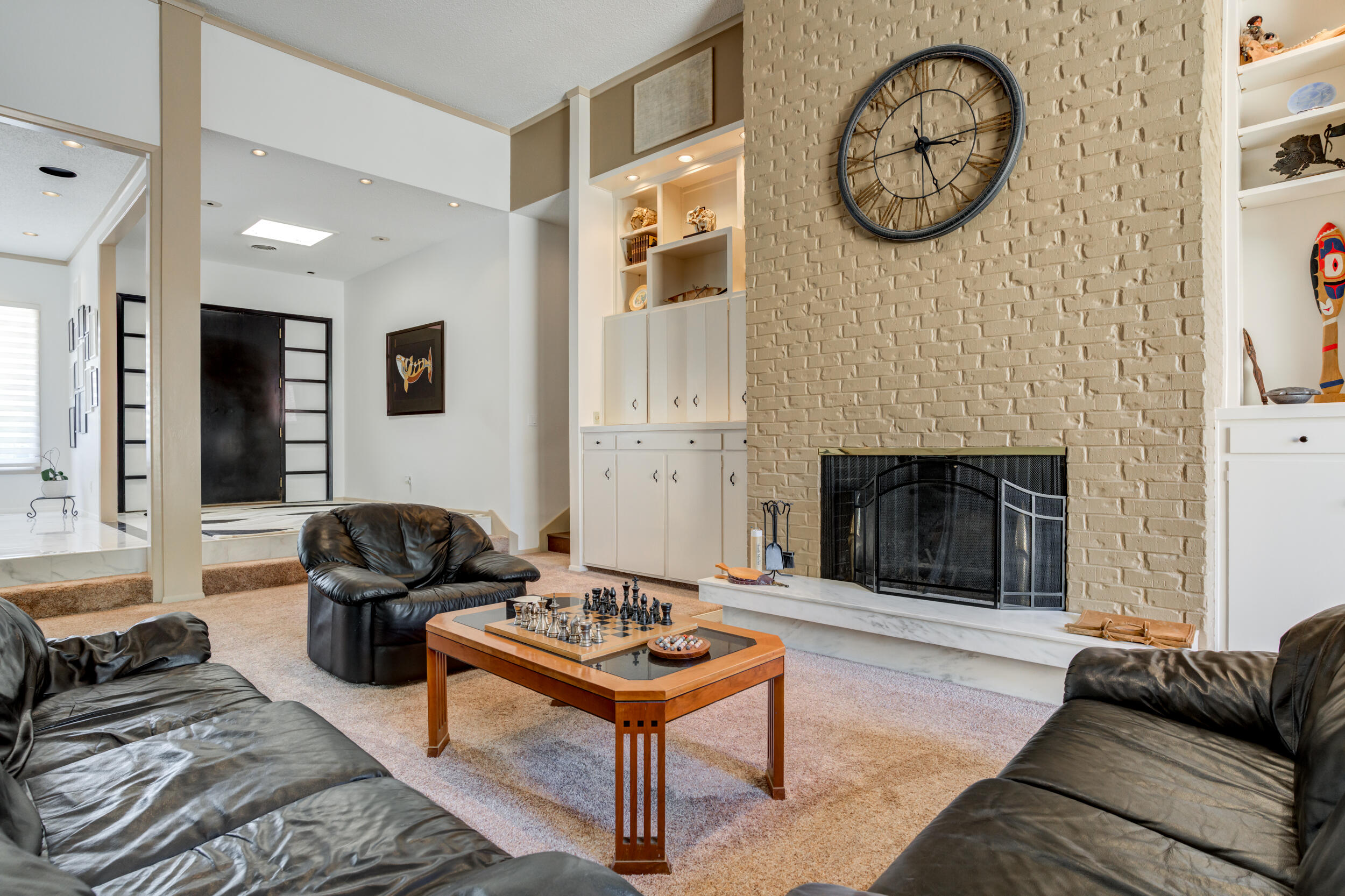 4528 7th Street Lubbock, TX 79416 - Photo 28 of 69 a living room with furniture a clock on wall and a fireplace