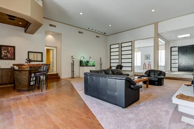 a spacious bedroom with a bed and a ceiling fan