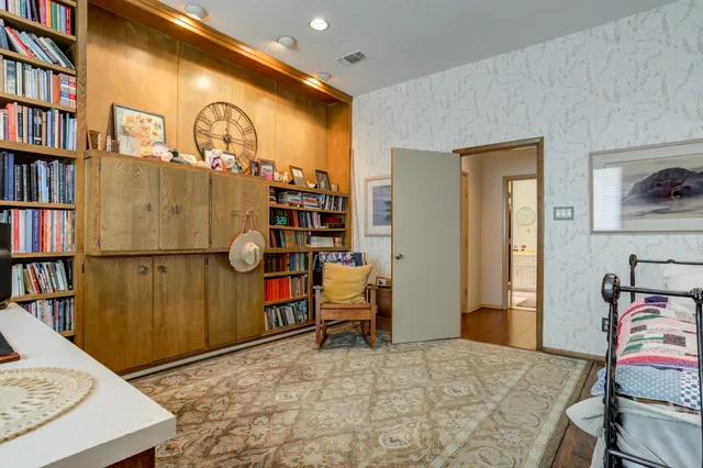 a living room with a bed furniture and a large window