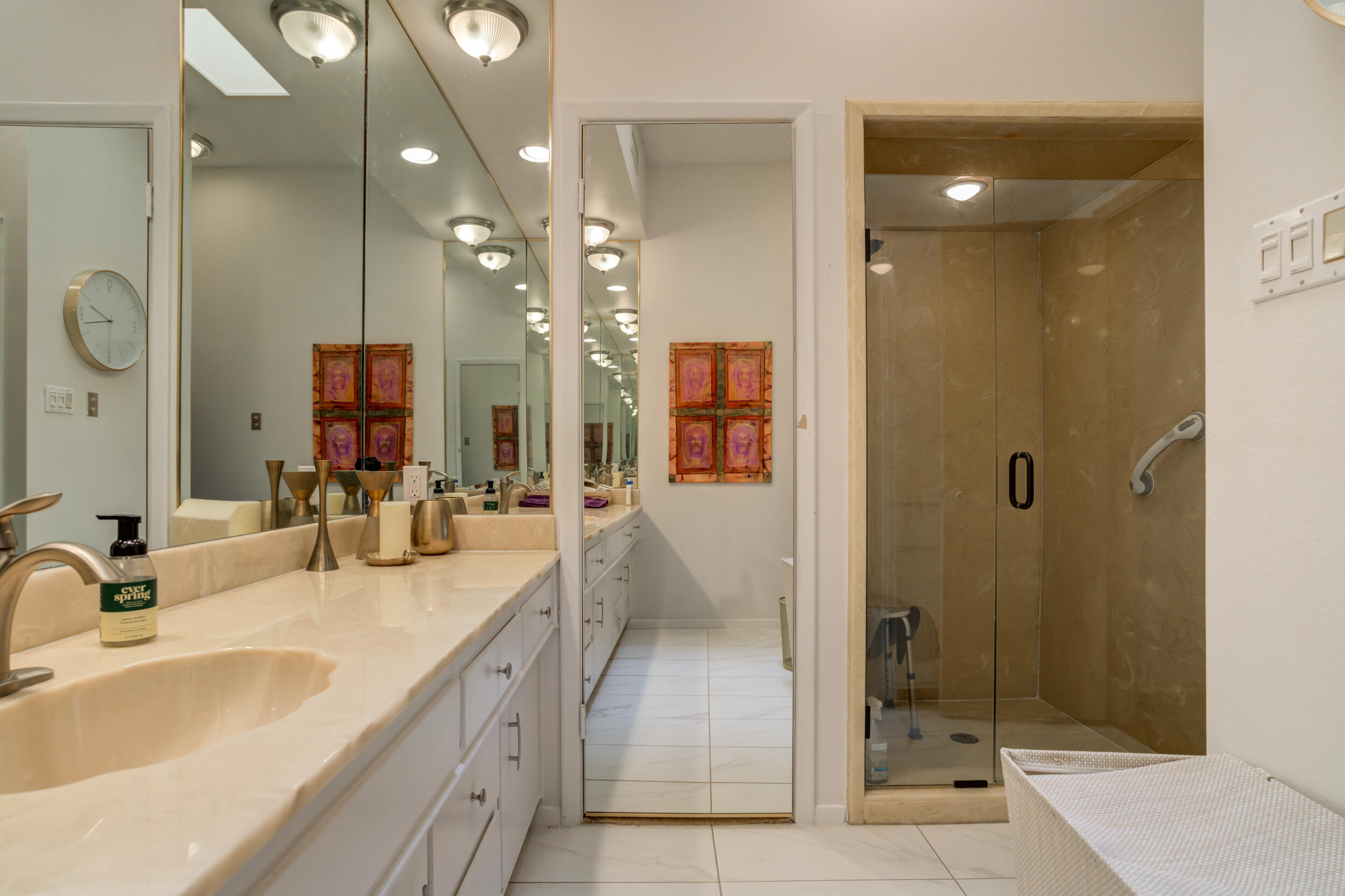 4528 7th Street Lubbock, TX 79416 - Photo 38 of 69 a bathroom with a granite countertop sink mirror and shower