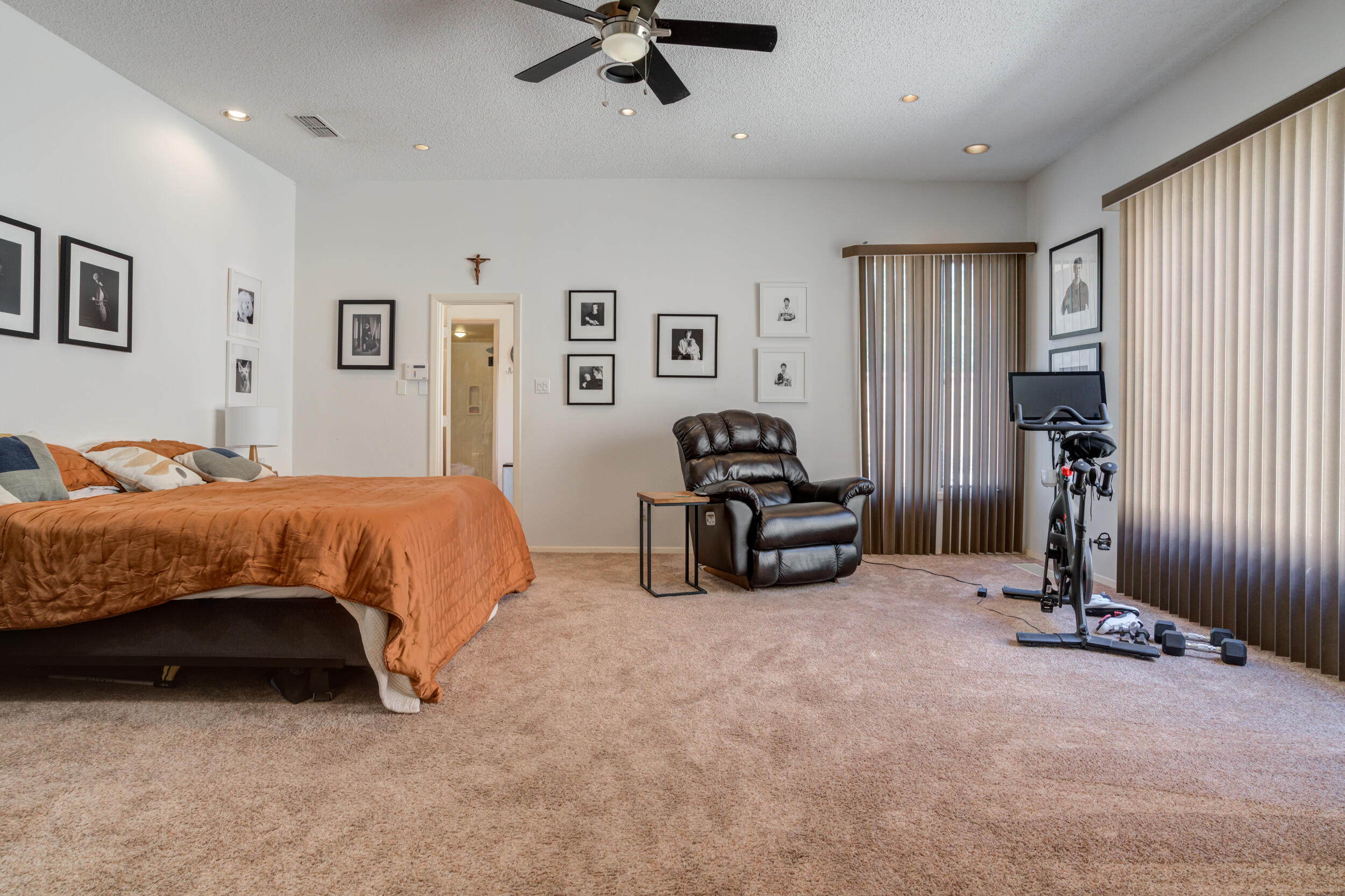 4528 7th Street Lubbock, TX 79416 - Photo 39 of 69 a spacious bedroom with a bed and a ceiling fan