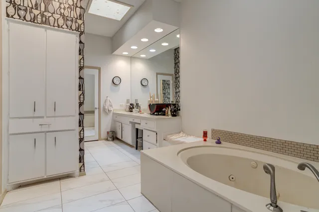 a utility room with cabinets washer and dryer