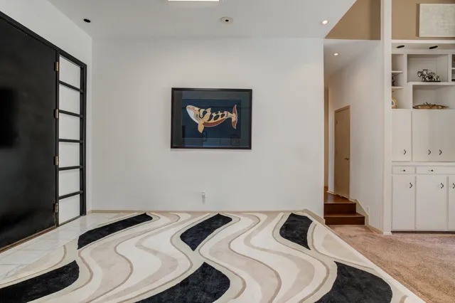 a bedroom with a bed and a painting on the wall