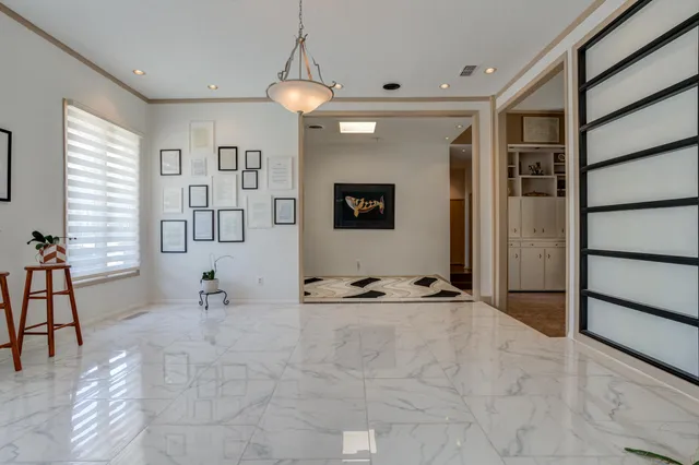 a kitchen with refrigerator a sink and chairs