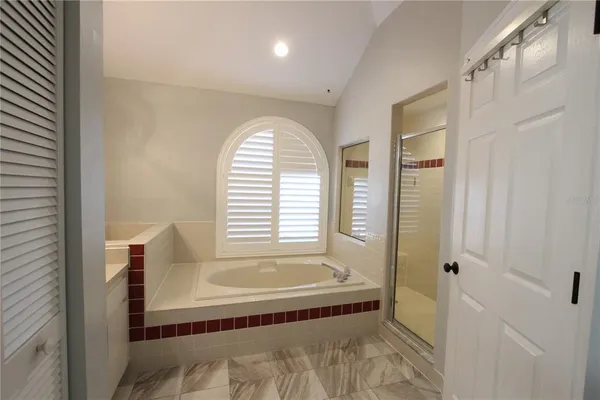 a bathroom with a bathtub and shower