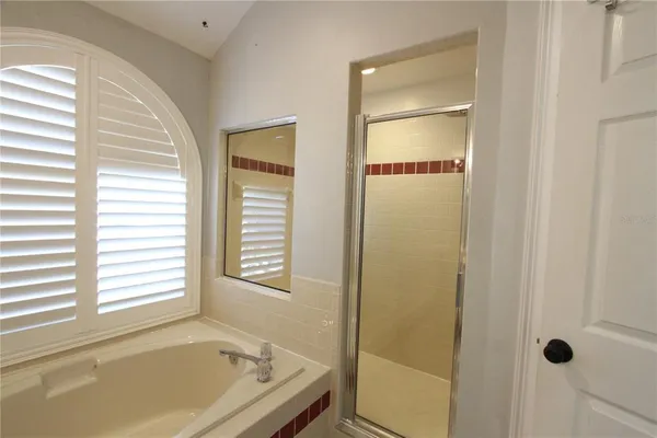 a bathroom with a tub and a window