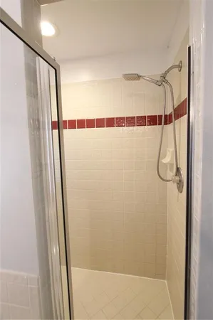 a bathroom with a shower and a mirror
