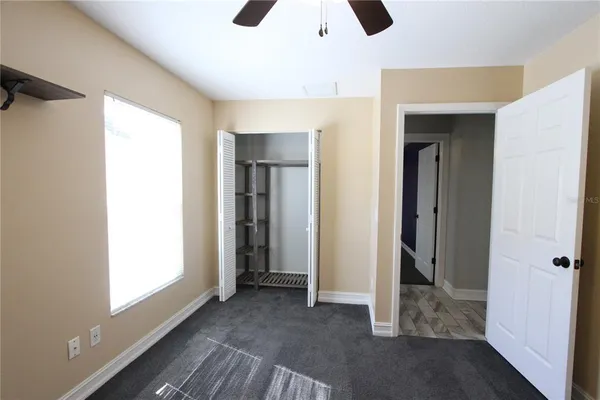 a view of room with window and ceiling fan
