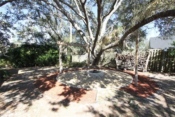 a view of backyard of house with green space