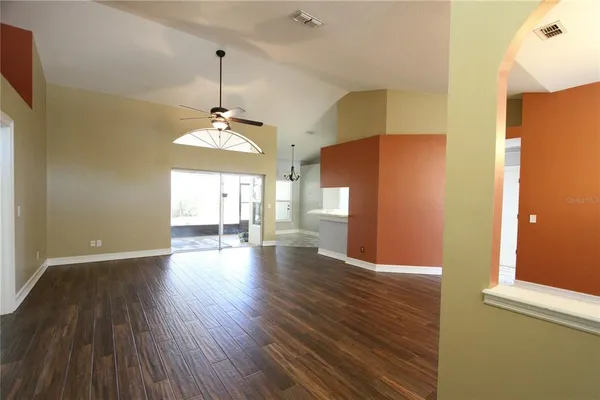 a view of a room with wooden floor and a window