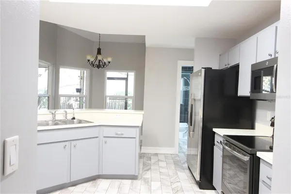 a kitchen with stainless steel appliances a sink stove and refrigerator