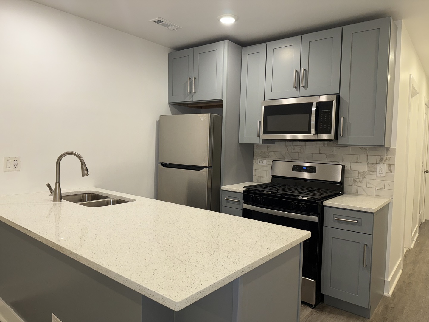 2731 South Homan Avenue, Unit 1 Chicago, IL 60623 - Photo 3 of 10 a kitchen with kitchen island a sink appliances and cabinets