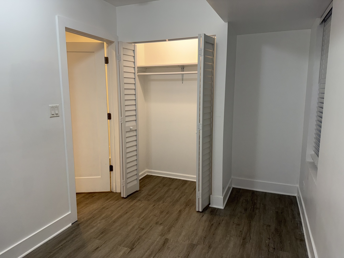 2731 South Homan Avenue, Unit 1 Chicago, IL 60623 - Photo 5 of 10 an empty room with wooden floor and closet