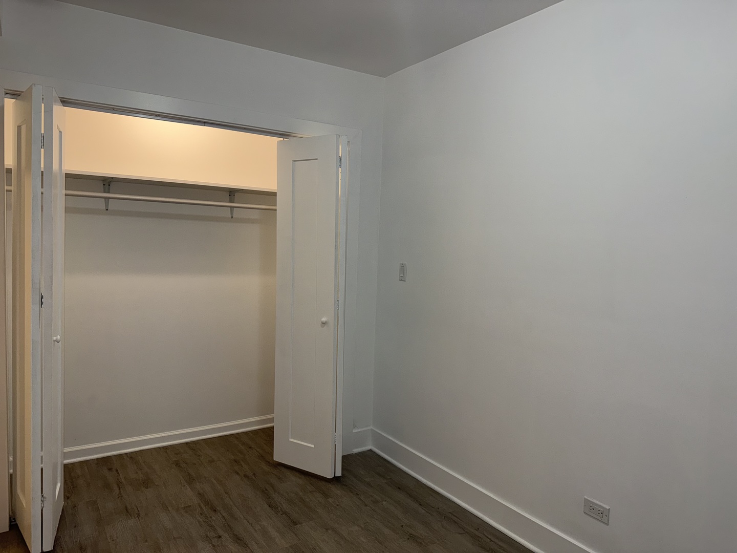 2731 South Homan Avenue, Unit 1 Chicago, IL 60623 - Photo 9 of 10 a view of an empty room with wooden floor and a window