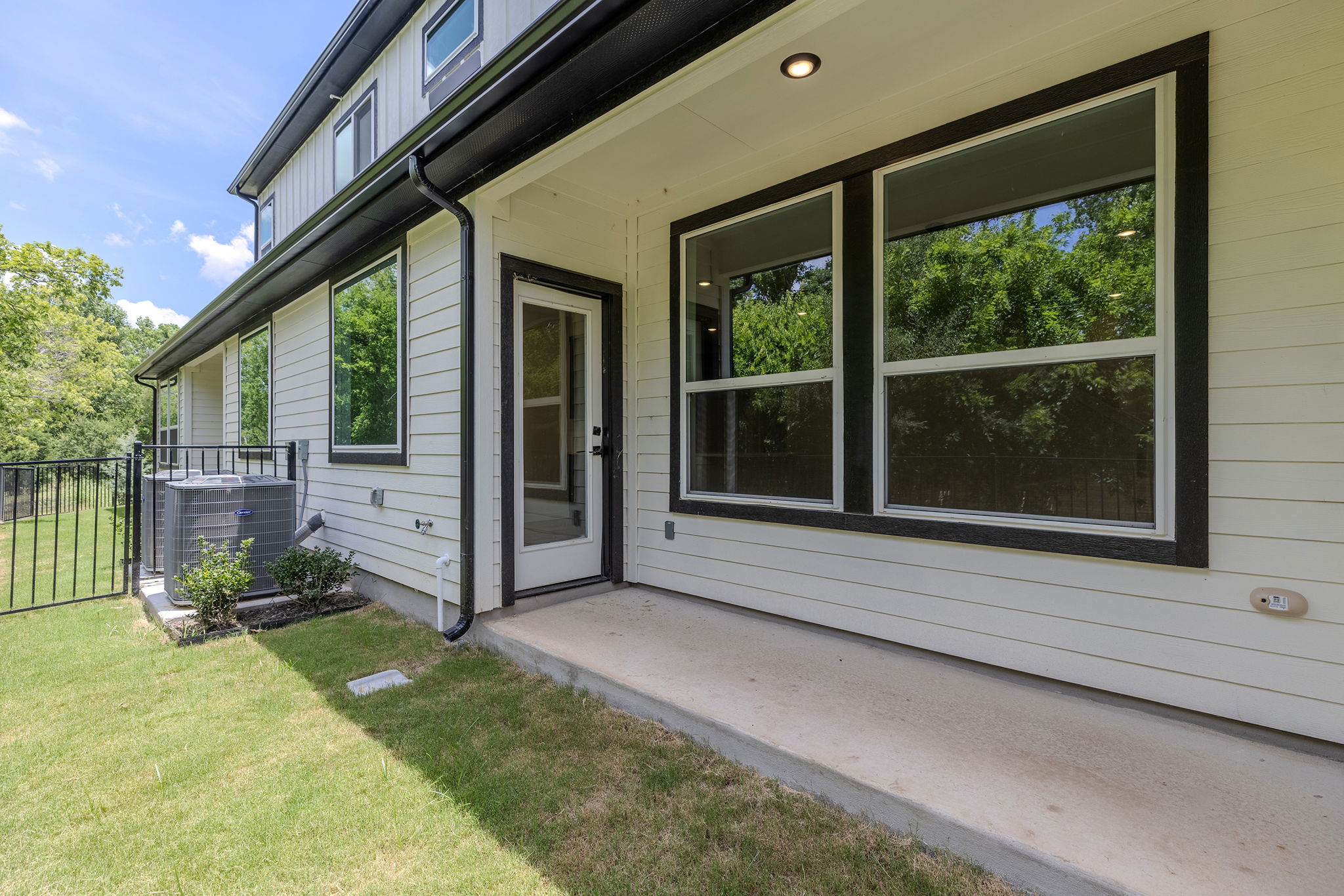2600 Gattis School Road, Unit 1002 Round Rock, TX 78664 - Photo 33 of 40 A private back patio overlooks a verdant fenced yard, perfect for outdoor relaxation.
