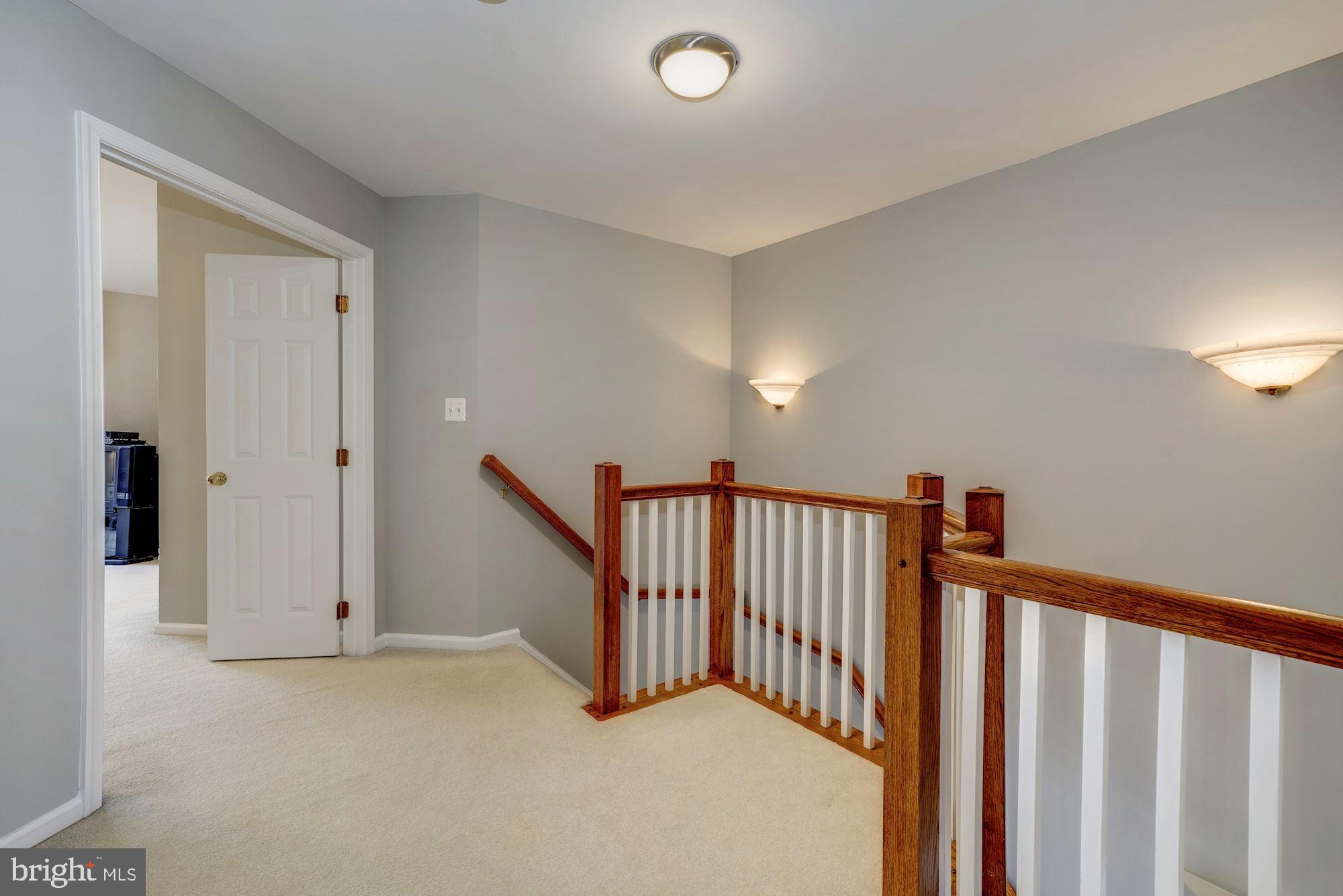 11516 Waterhaven Court Reston, VA 20190 - Photo 19 of 46 Wood Staircase to Upper Hallway with Linen Closet