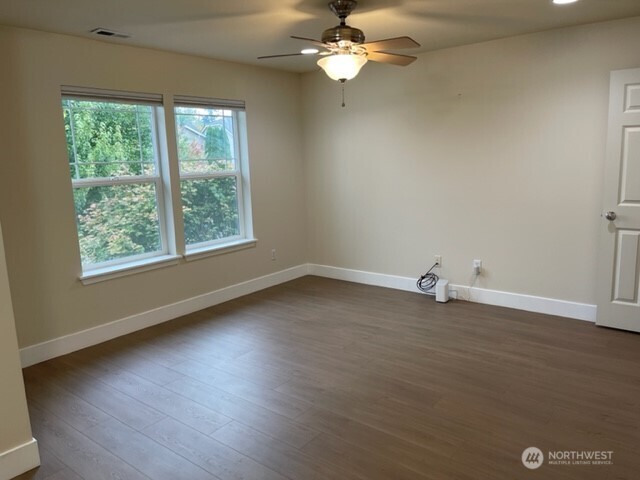 20446 Corbridge Road Southeast Monroe, WA 98272 - Photo 17 of 31 an empty room with wooden floor and windows