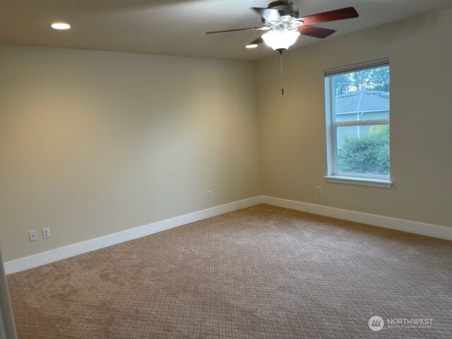20446 Corbridge Road Southeast Monroe, WA 98272 - Photo 18 of 31 an empty room with a chandelier fan and windows