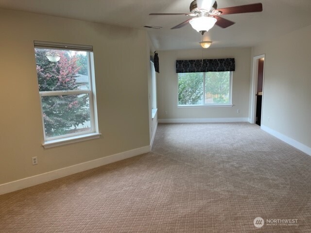 20446 Corbridge Road Southeast Monroe, WA 98272 - Photo 20 of 31 a view of a livingroom with a large window a ceiling fan and chandelier fan