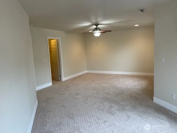 a view of an empty room with a fan