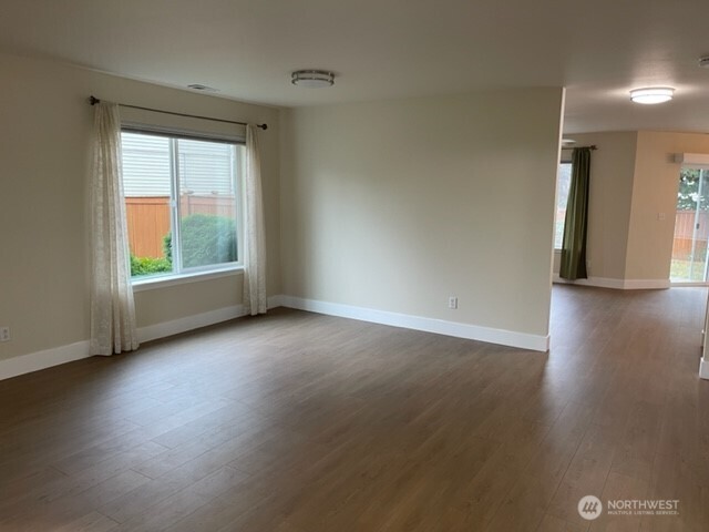 20446 Corbridge Road Southeast Monroe, WA 98272 - Photo 3 of 31 an empty room with wooden floor and windows