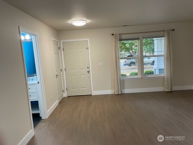 20446 Corbridge Road Southeast Monroe, WA 98272 - Photo 5 of 31 an empty room with a window and a kitchen