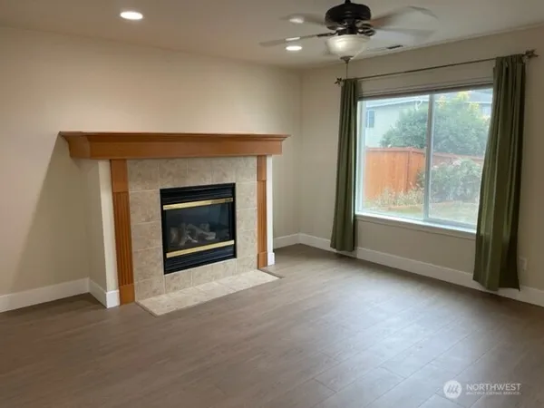an empty room with fireplace and windows