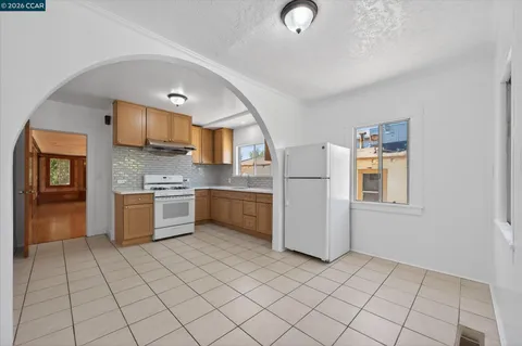 a kitchen with a refrigerator sink and cabinets