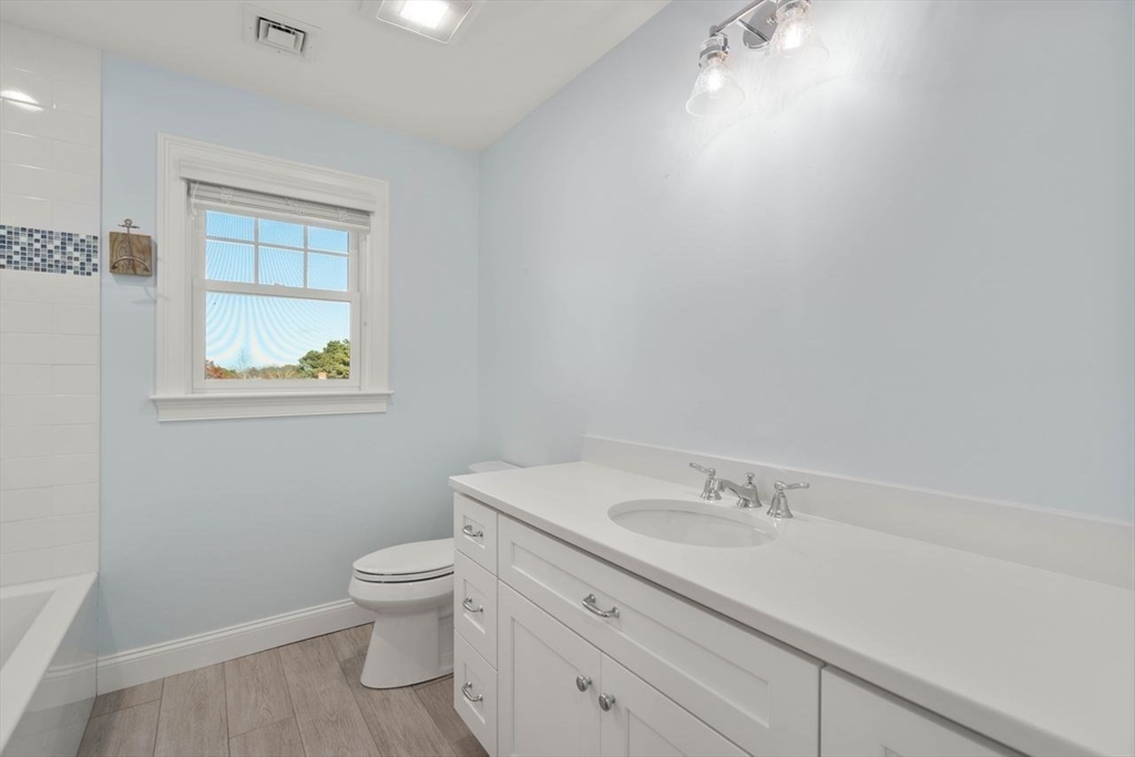 1 Dillingham Avenue Sandwich, MA 02563 - Photo 14 of 36 a bathroom with a granite countertop toilet a sink and a window