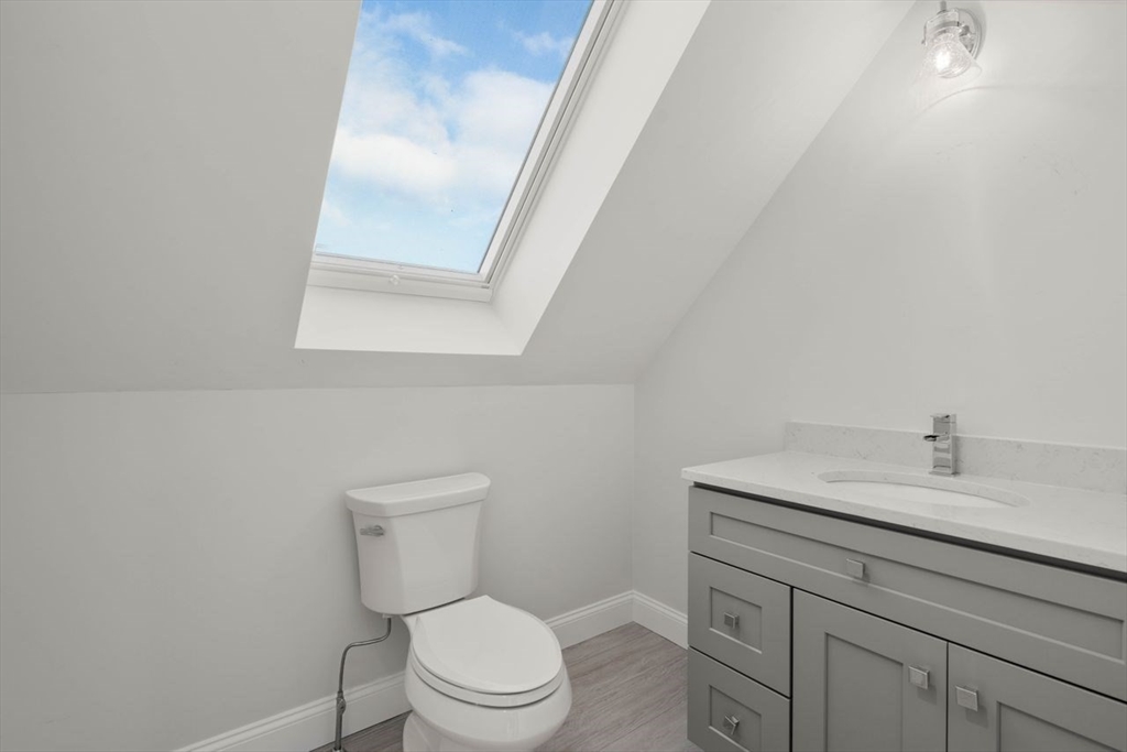1 Dillingham Avenue Sandwich, MA 02563 - Photo 25 of 36 a bathroom with a toilet a sink a vanity and mirror