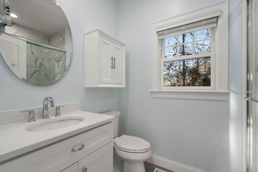 1 Dillingham Avenue Sandwich, MA 02563 - Photo 8 of 36 a bathroom with a toilet a sink a mirror and a window