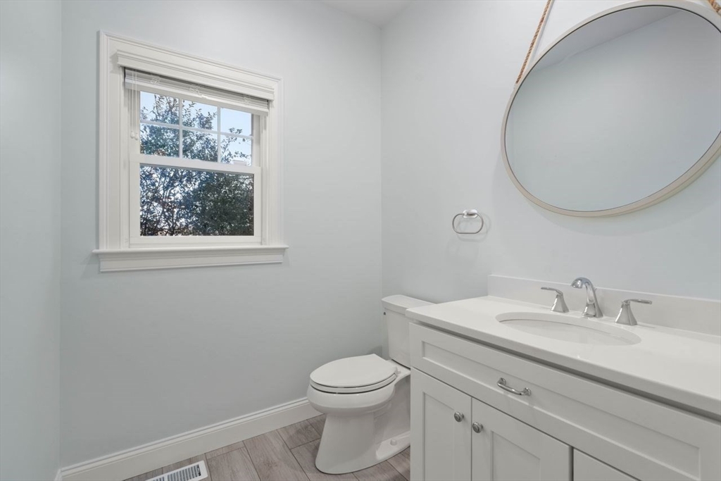 1 Dillingham Avenue Sandwich, MA 02563 - Photo 10 of 36 a bathroom with a toilet a sink a mirror and a window