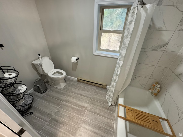 2807 North Ogden Canyon Road Eden, UT 84310 - Photo 28 of 72 Full bathroom featuring a white toilet, tub with a shower, and wood-finish tile flooring