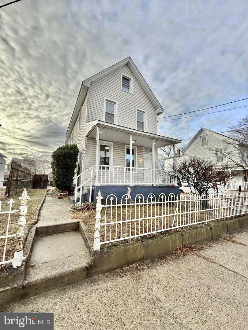 a view of a white house with a yard and table and chair