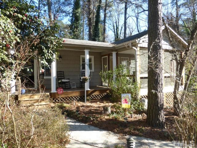 1216 Brookside Drive Raleigh, NC 27604 - Photo 1 of 24 Escape to this enchanted, updated cottage almost hidden in plain sight on 0.37 scenic acres near the Oakwood Dog Park and Conn School.