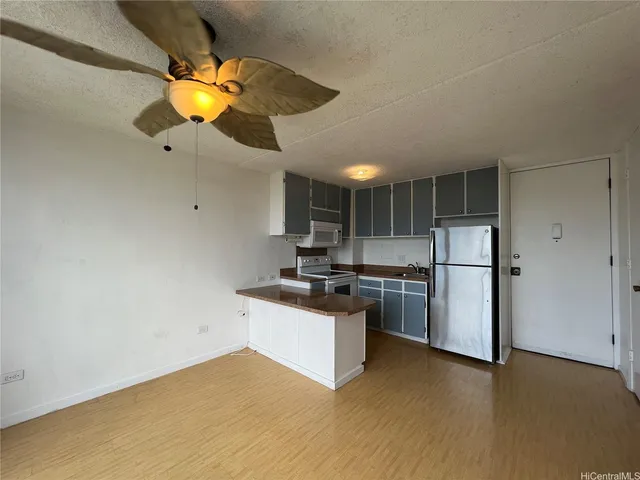 a kitchen with stainless steel appliances granite countertop a sink and a stove