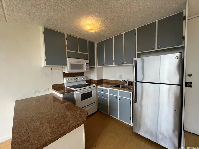 a kitchen with a refrigerator and a stove